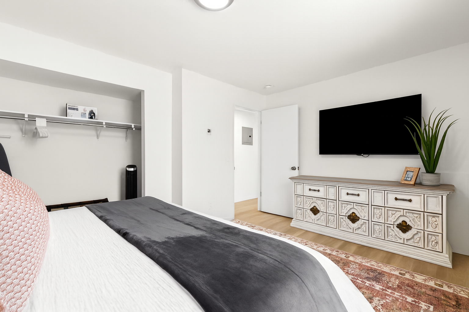 Kick back in bed and enjoy your favorite shows on the wall-mounted smart TV.