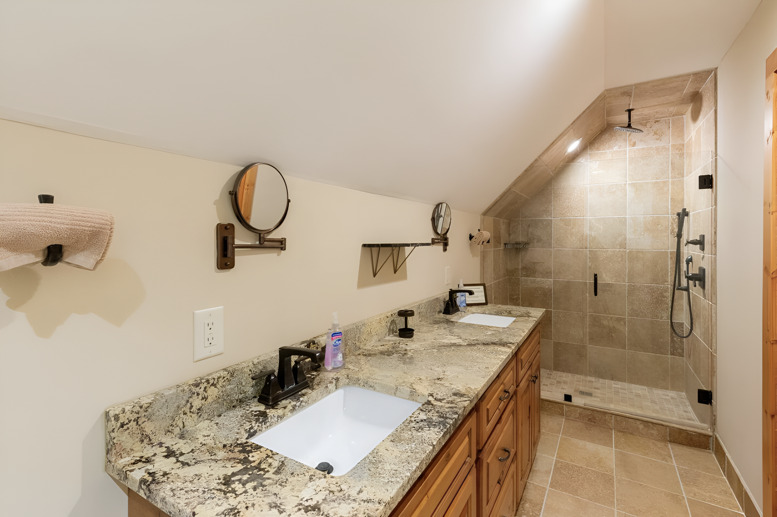 Our bathroom is built for your convenience, featuring a large shower and two sinks.