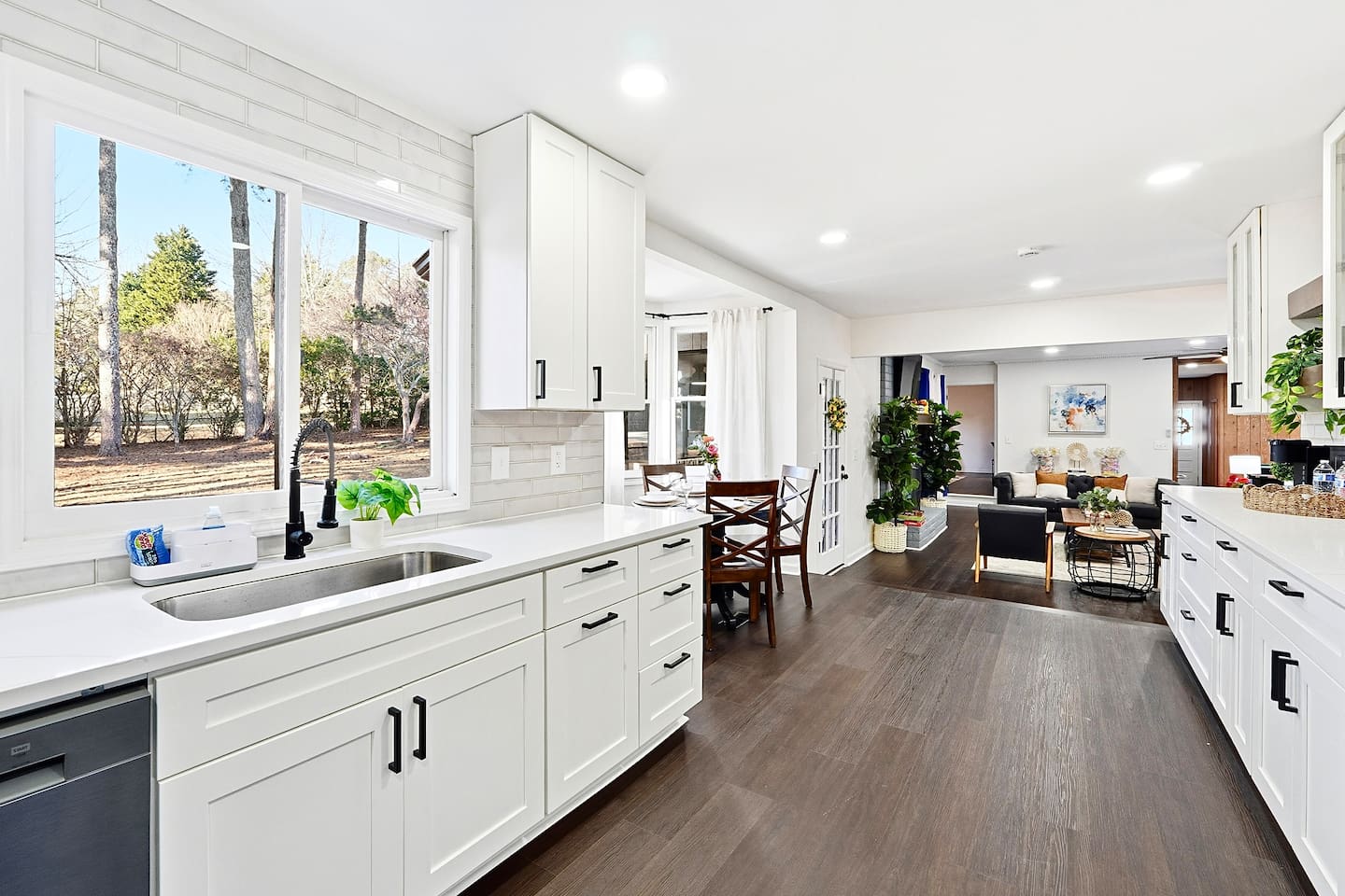 Bright white kitchen with a sleek, extended layout and ample counter space. The long layout offers plenty of countertop space, perfect for cooking, prepping, and everyday meals. Fully stocked with everything you need for a comfortable stay!
