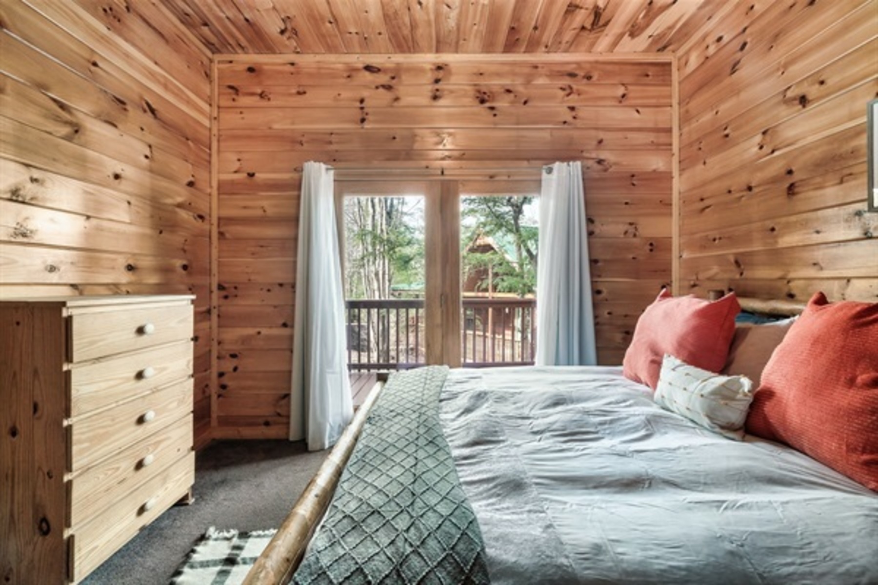 Settle into a lower level king bedroom with Jack and Jill bath access and doors that open to fresh mountain air.