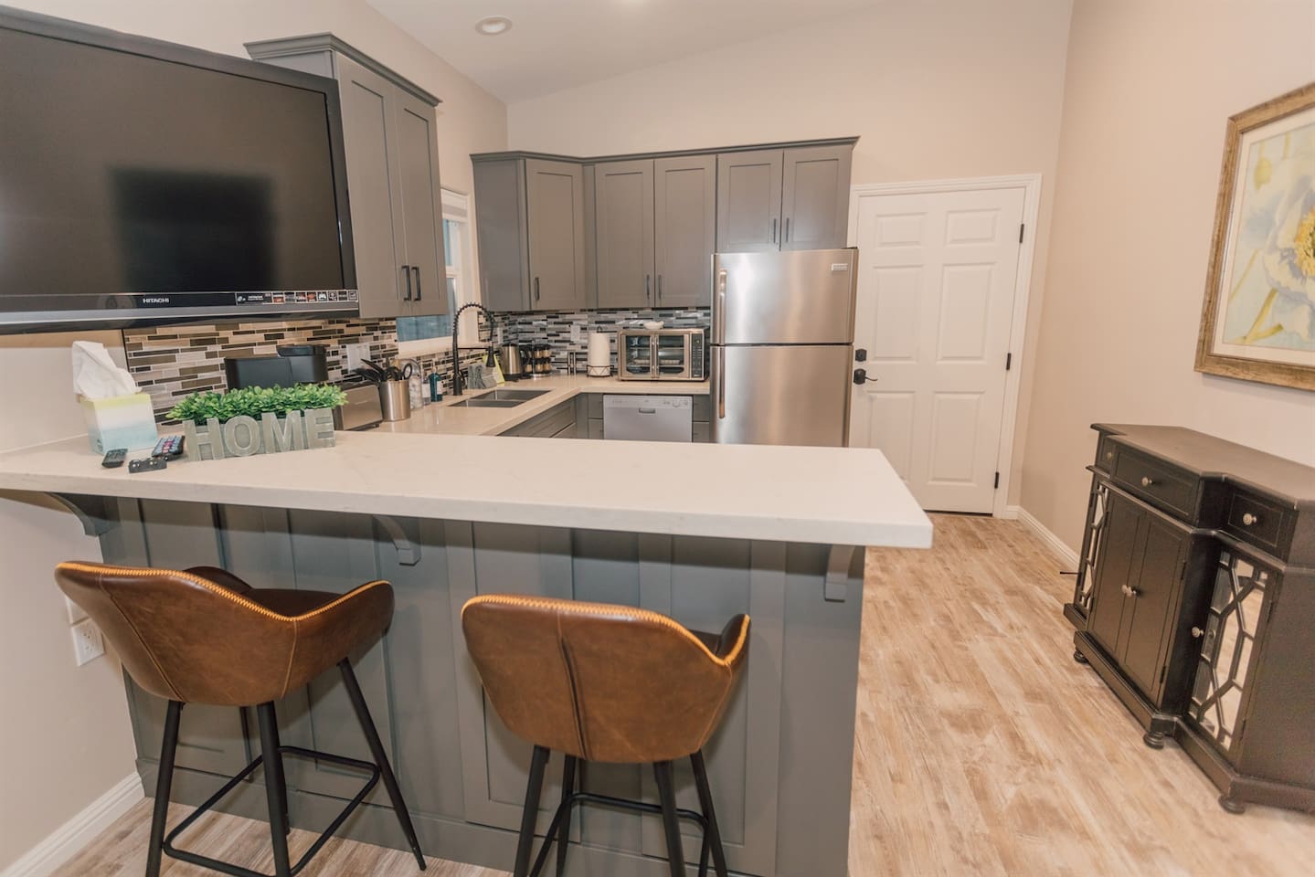 Kitchenette and bar with 50" smart TV.