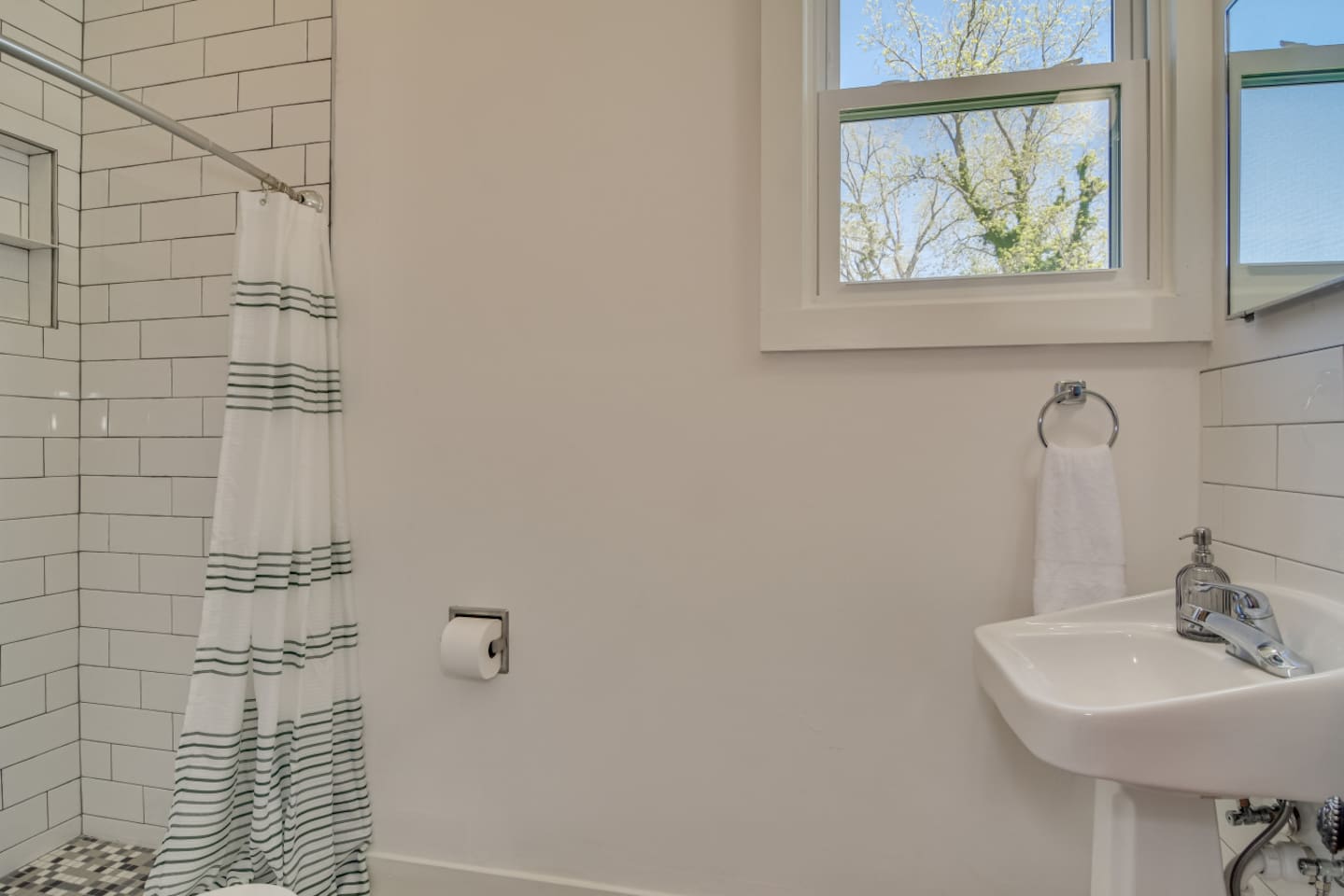 Full bathroom with walk-in shower and modern finishes.