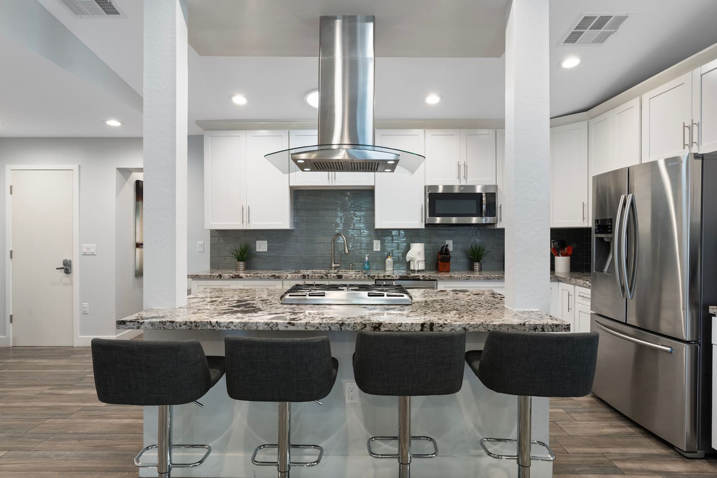 Stylish dining table with a central gas stove, built-in exhaust, and comfortable seating for four, ideal for family meals and cooking together.