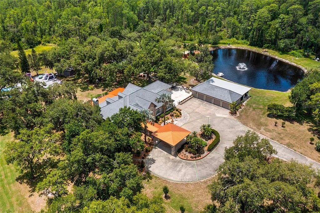 Aerial view showcasing the entire estate and sparkling lake