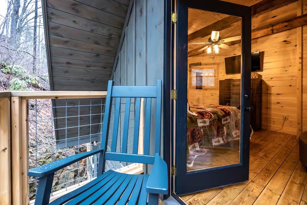 Wake up in the top-level king bedroom at Bear Paws Cabin and step straight out to your private balcony. Soaring exposed timber beams and hand-crafted log walls make this one of the most unique bedrooms in any Gatlinburg cabin