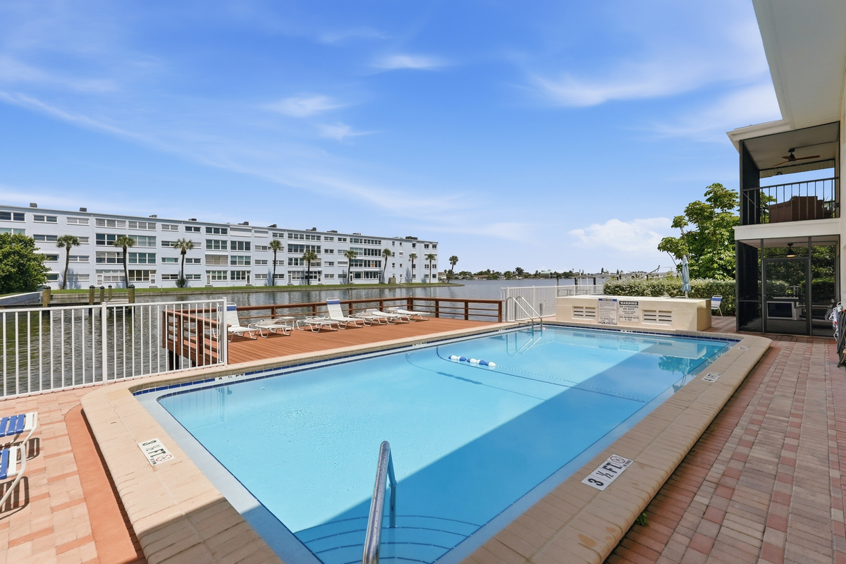 Enjoy access to the shared heated outdoor pool, where you can cool off, soak up the Florida sunshine, and take in the stunning bay views from the pool deck.