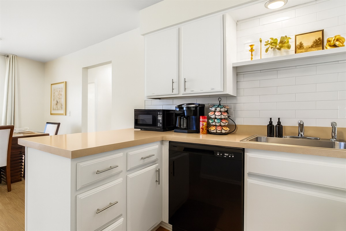 Sleek and modern kitchen with updated appliances, perfect for enjoying meals at home.