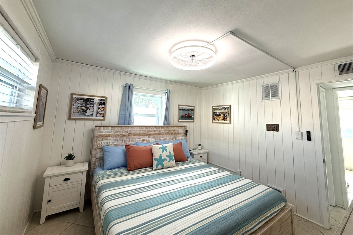 Primary Bedroom Alternate View with King Bed & Retro Photos & 65" TV