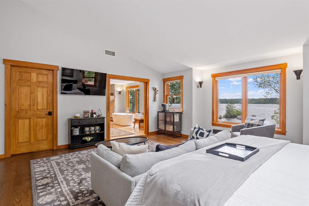 Second floor master bedroom ensuite with king bed and couch and its own bathroom