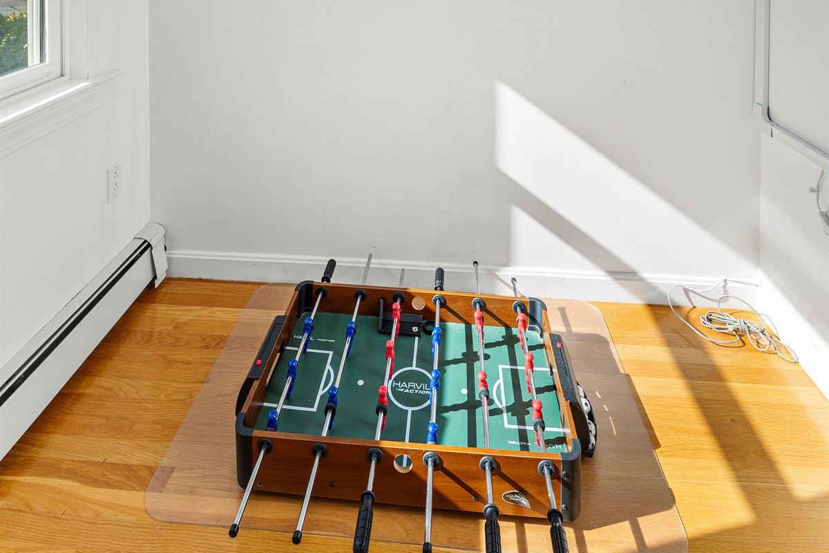 Mini foosball table for endless indoor entertainment.