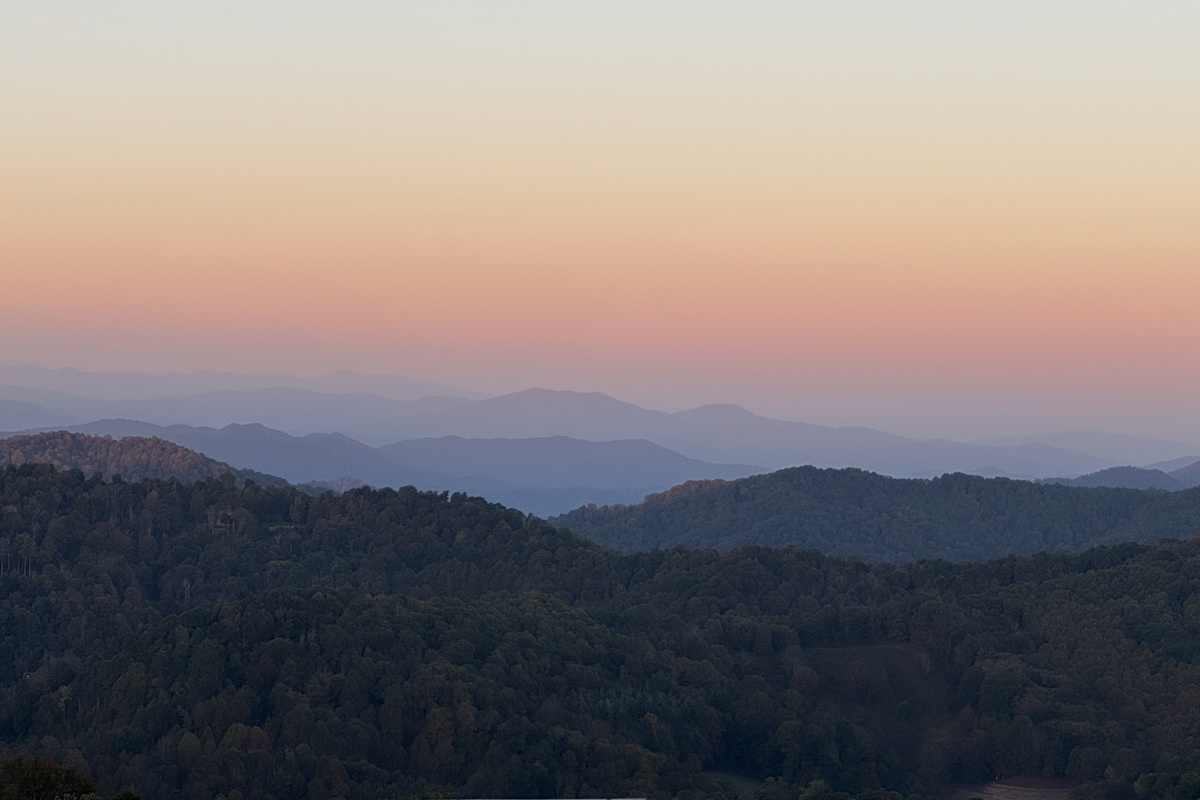 Soft evening colors settle over the layers of Blue Ridge mountain ridges.