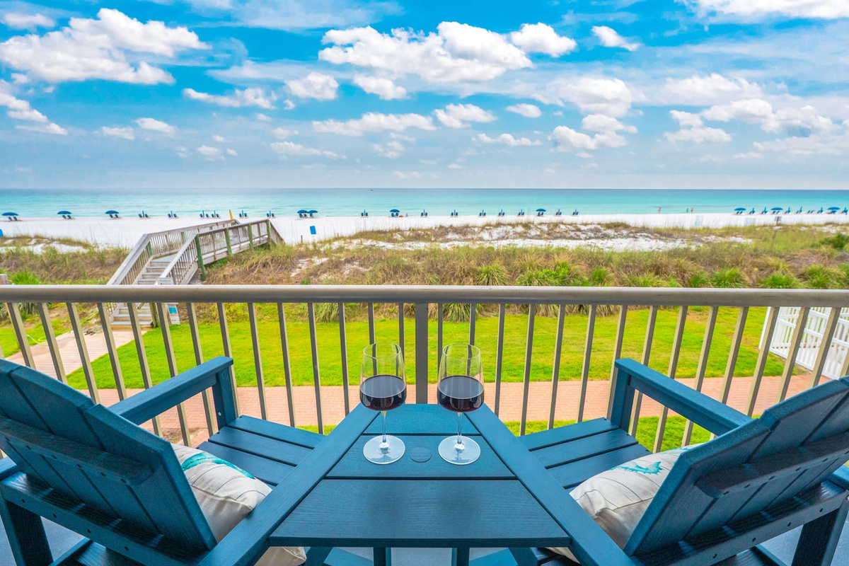 Private Gulf-front balcony overlooking Destin’s white sand and emerald water.