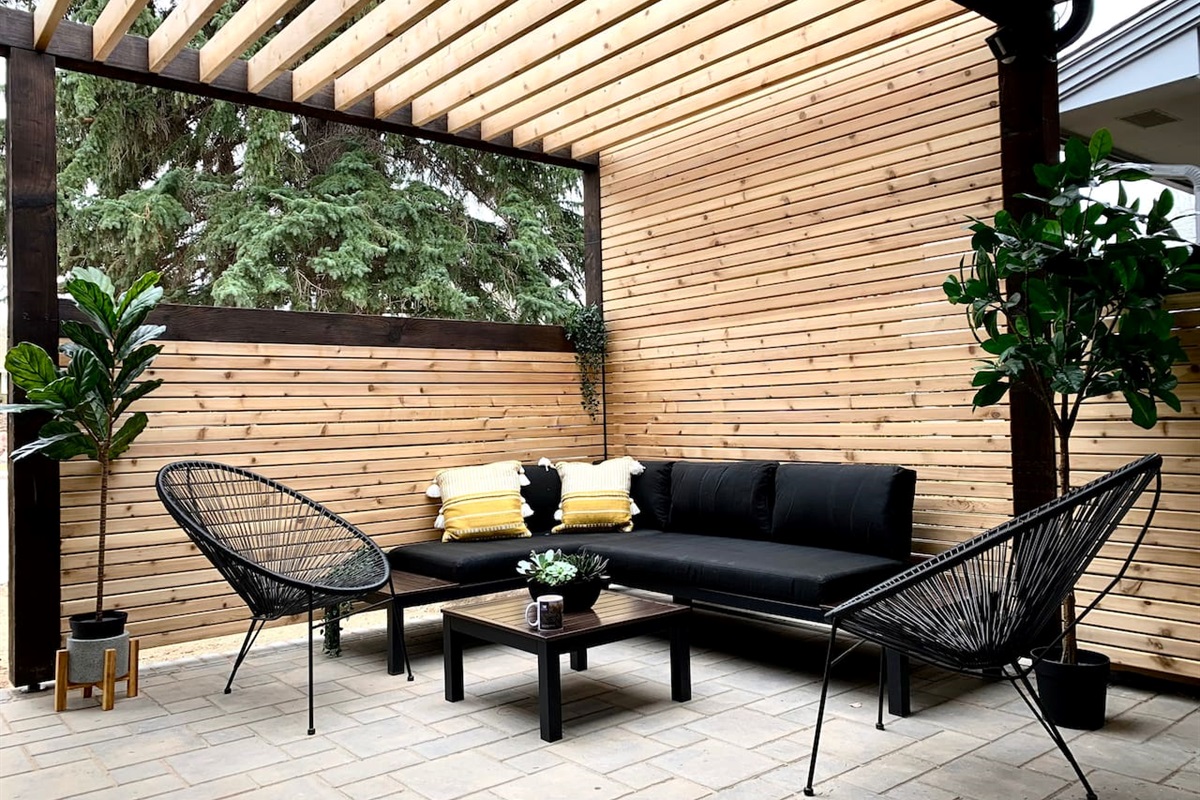Private side patio with seating — designed for guest use in warmer months.