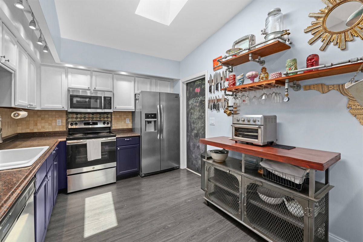 Picture of the kitchen from the hallway, showing how the two spaces connect and highlighting cool kitchen features!