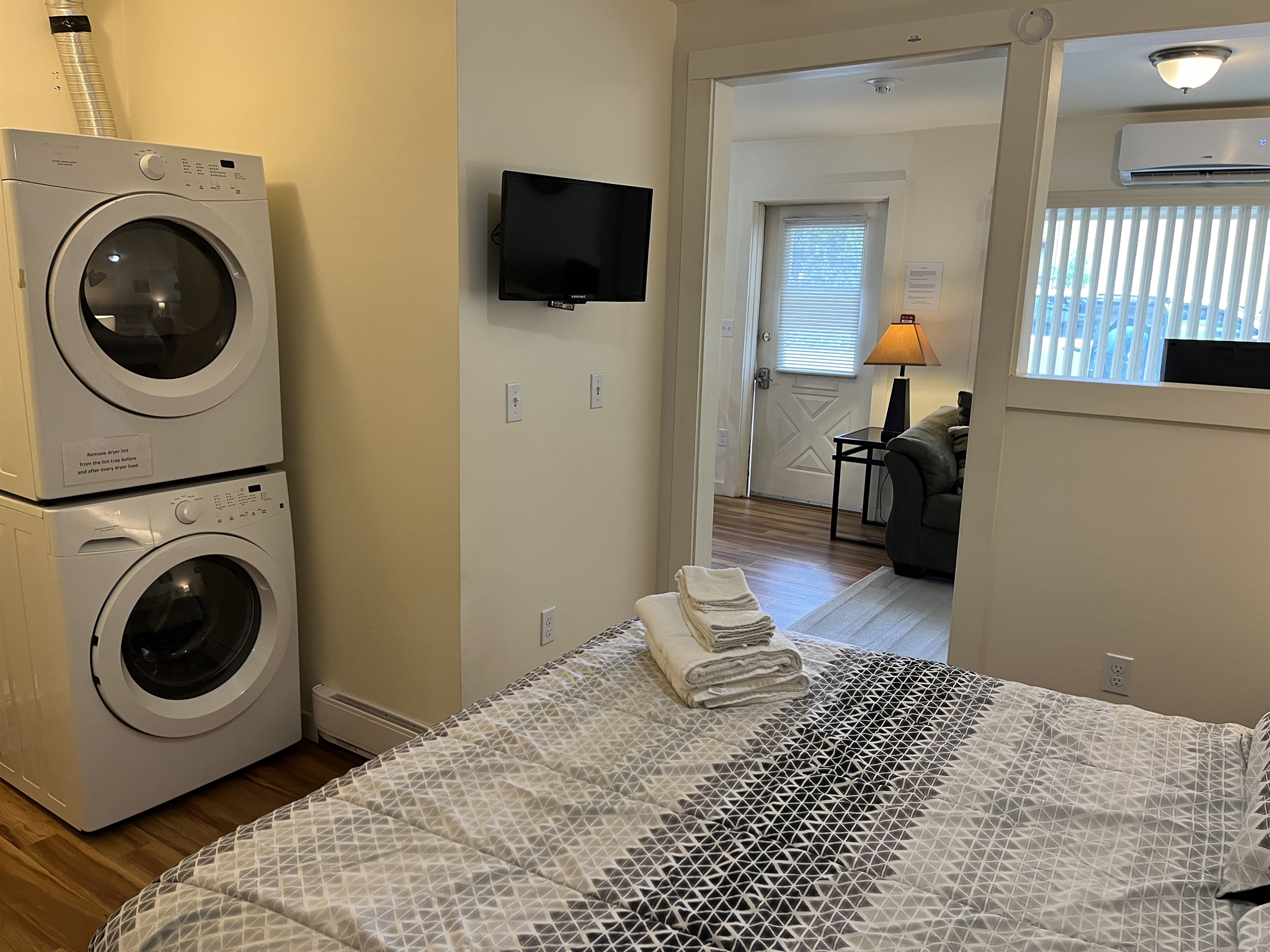 Queen sleeping area w/ laundry and living area beyond