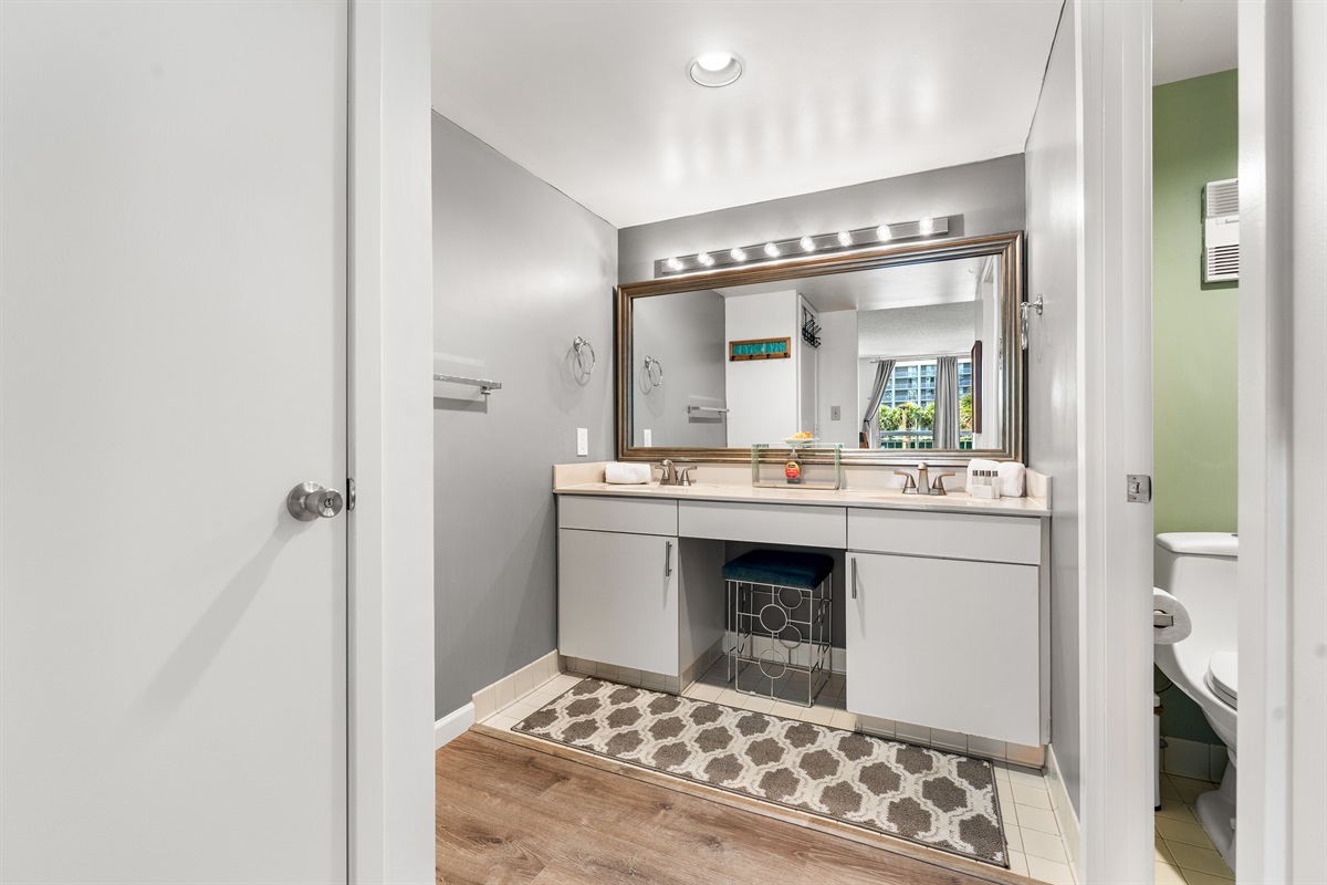 Main bathroom with double sinks, seperate toilet and tub/shower room