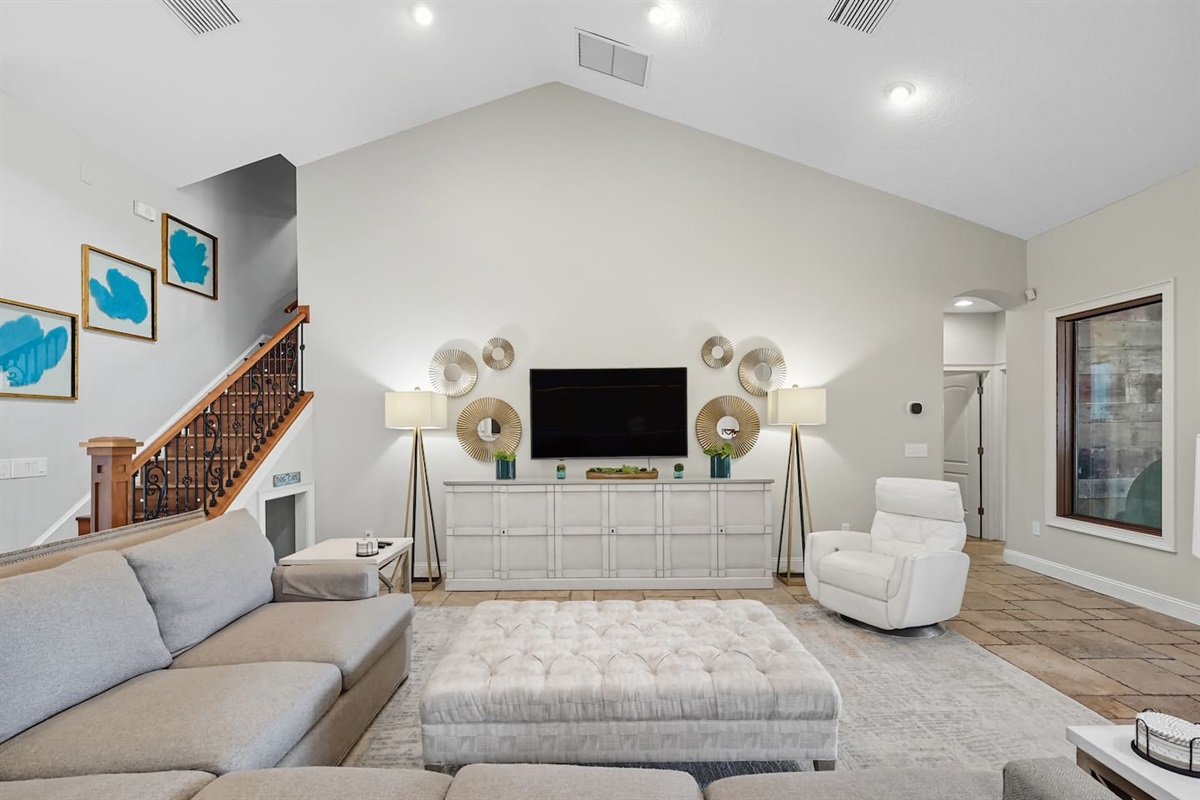 Living room with huge sectional and curved TV