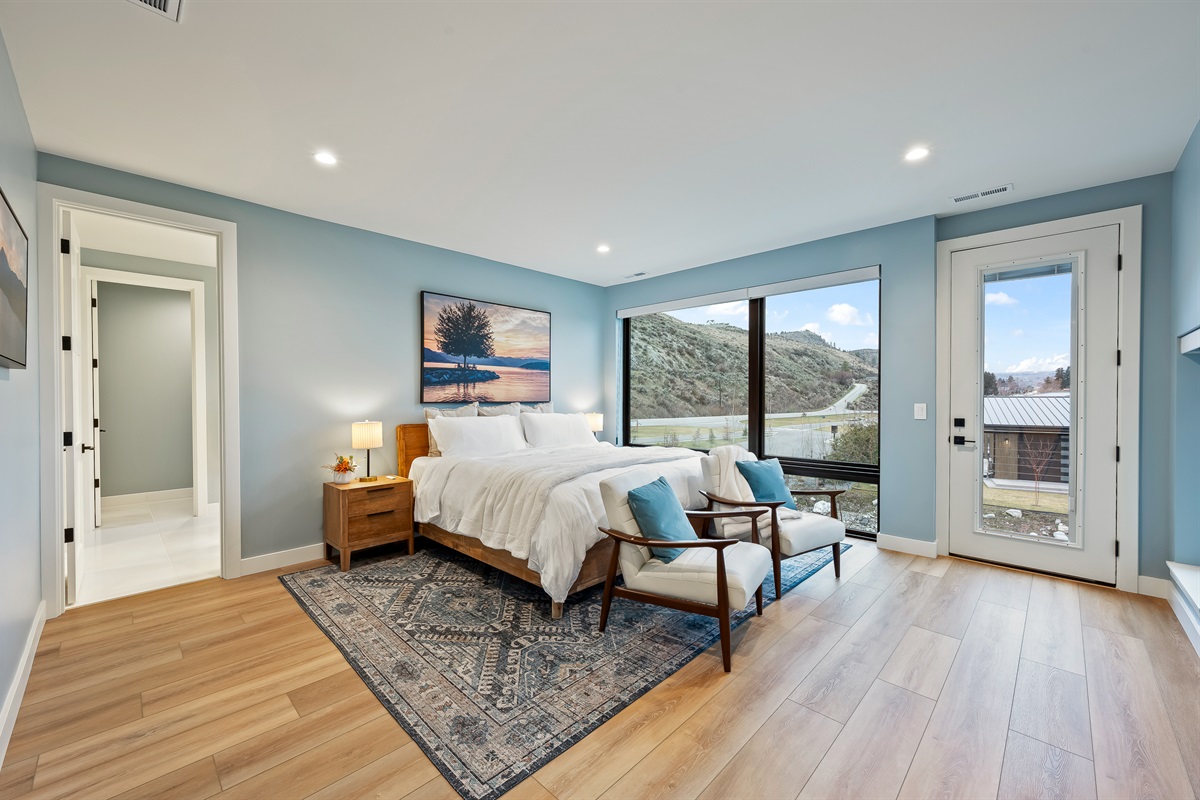 Primary: Bedroom #6 of 7 - Upstairs, king bed, Smart TV, large walk-in closet with crib, and ensuite with soaking tub, walk in shower, and lake views