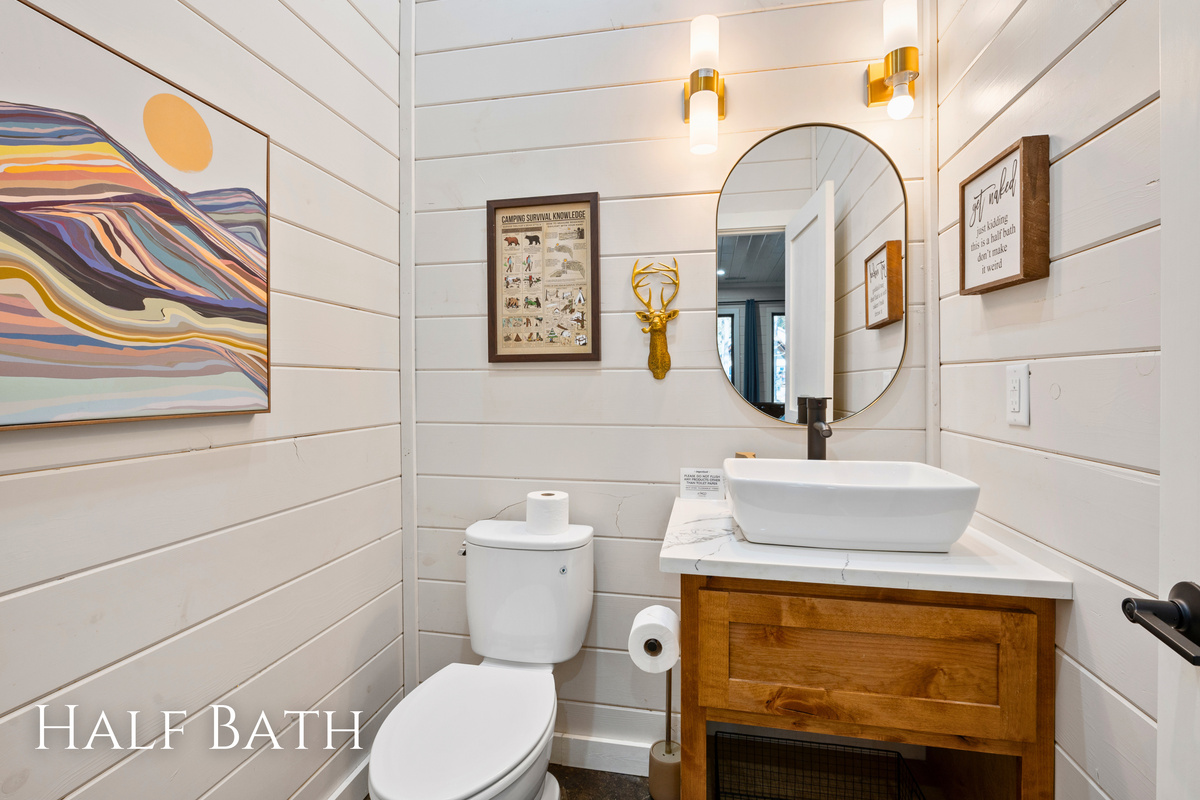 This convenient half bath is thoughtfully located just off the game room, making it easy to freshen up without missing out on the fun.