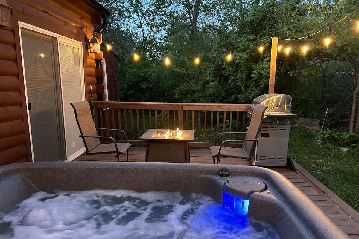 Fire table and propane grill by hot tub.