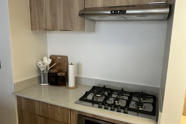 Fully equipped kitchen with full-size refrigerator, gas cooktop, oven, microwave, cookware, and plenty of counter space for meals at home. 🍳☕✨