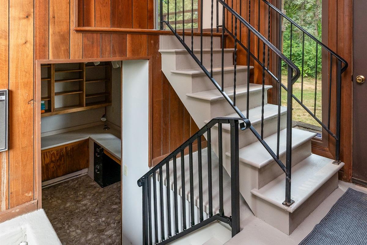 Unique split-level entryway with warm wood paneling, natural light, and open sightlines to multiple levels.