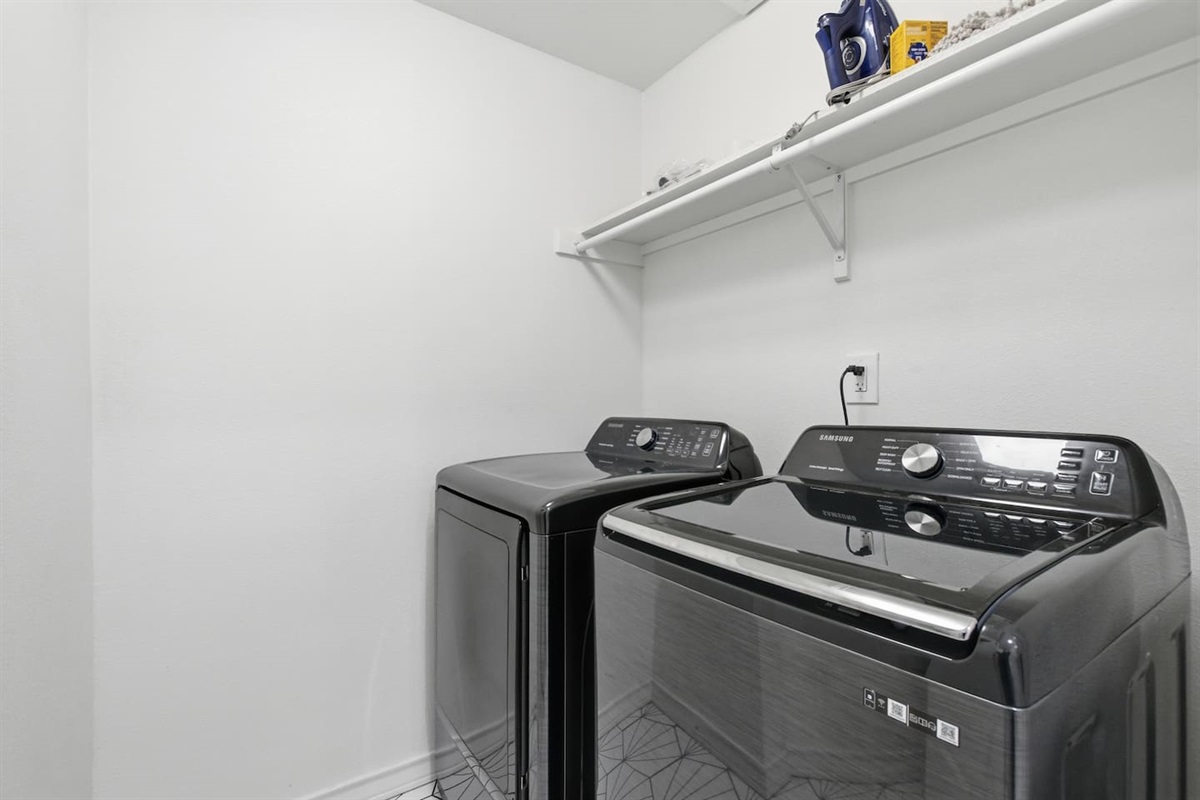 Private laundry room with modern washer and dryer for guest convenience.
