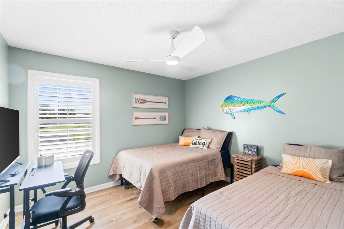 Third bedroom with two beds and workspace