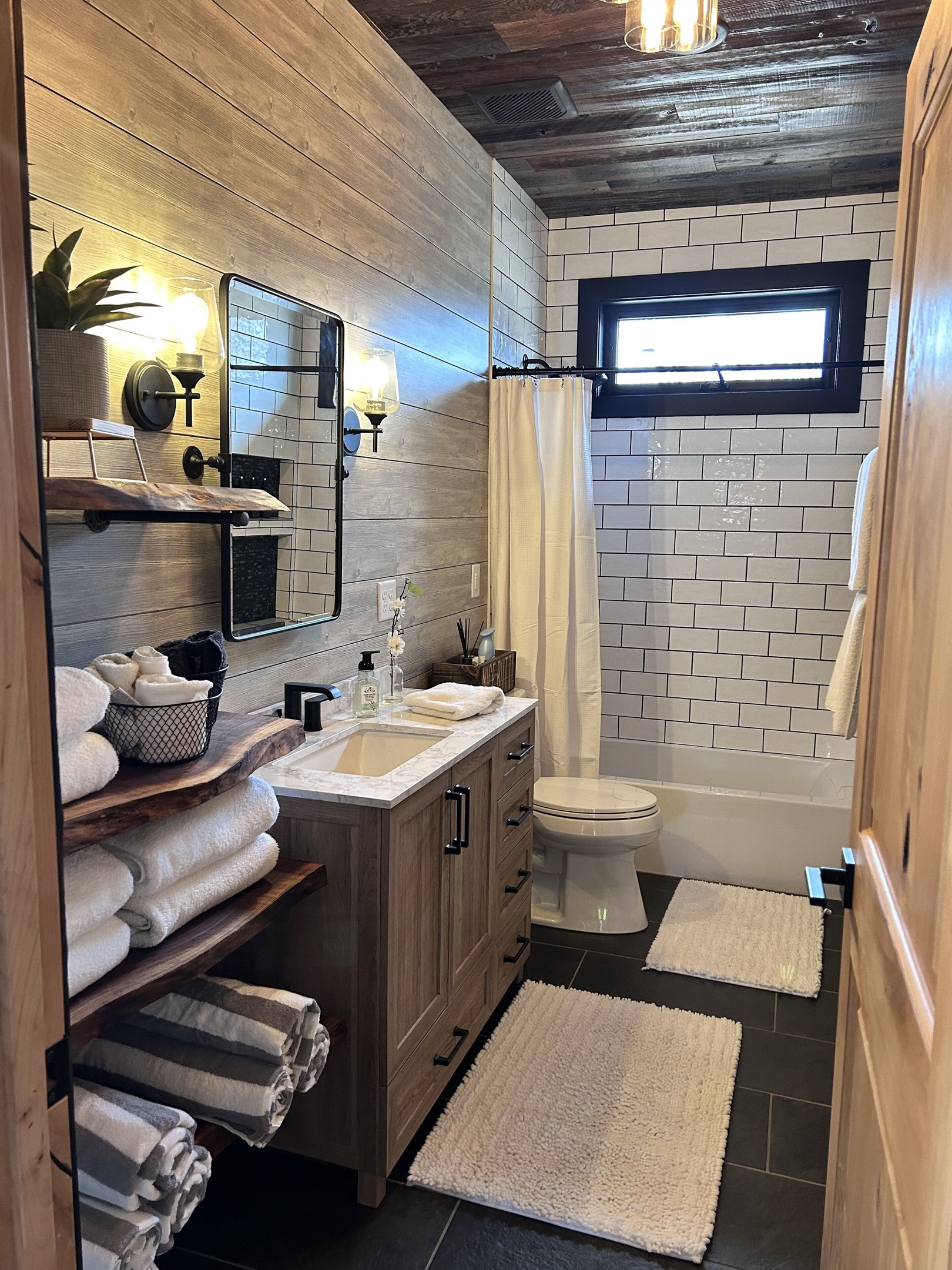 Full bathroom with live edge shelves