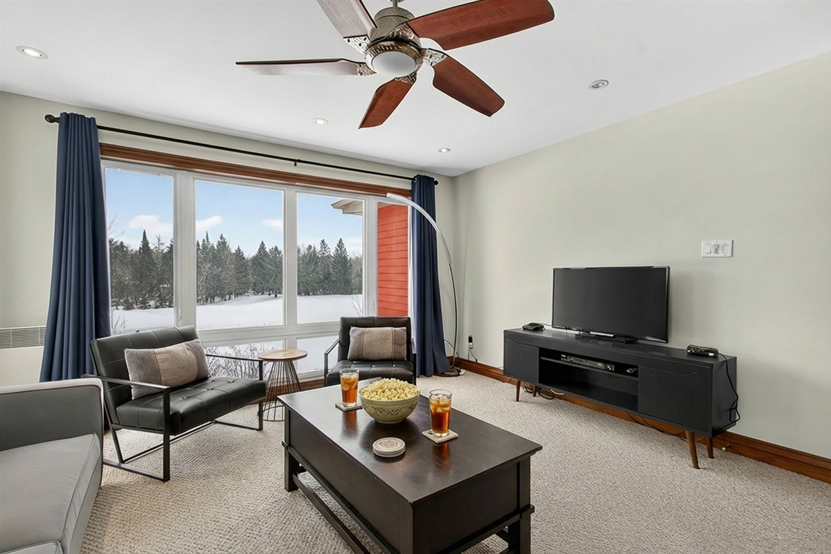 Upstairs living area w/ wall-to-wall windows & seating