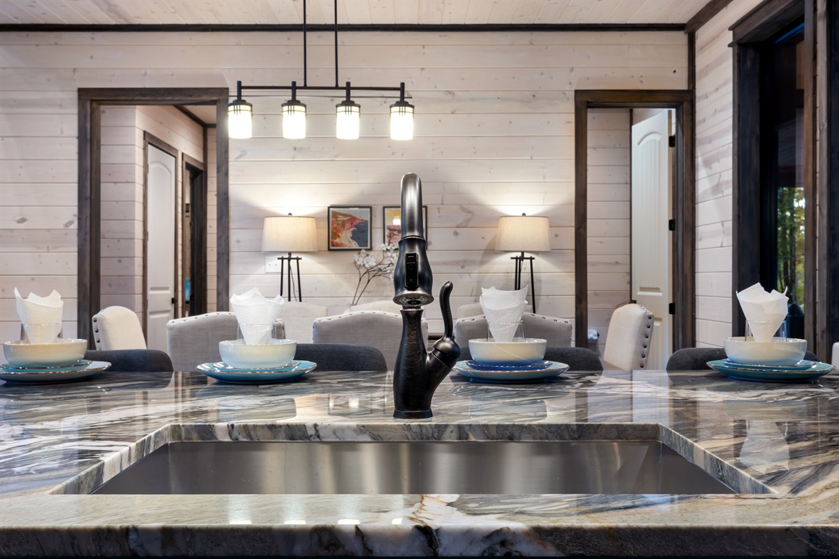 Spacious kitchen island with seating for four, perfect for casual meals, morning coffee, or gathering while cooking together.