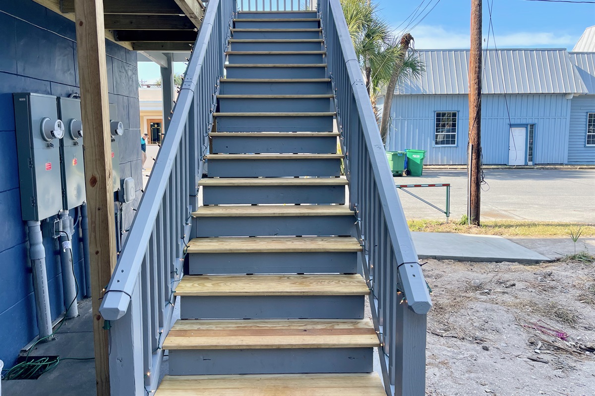 Rear stairs closest to the parking lot leading to apartments