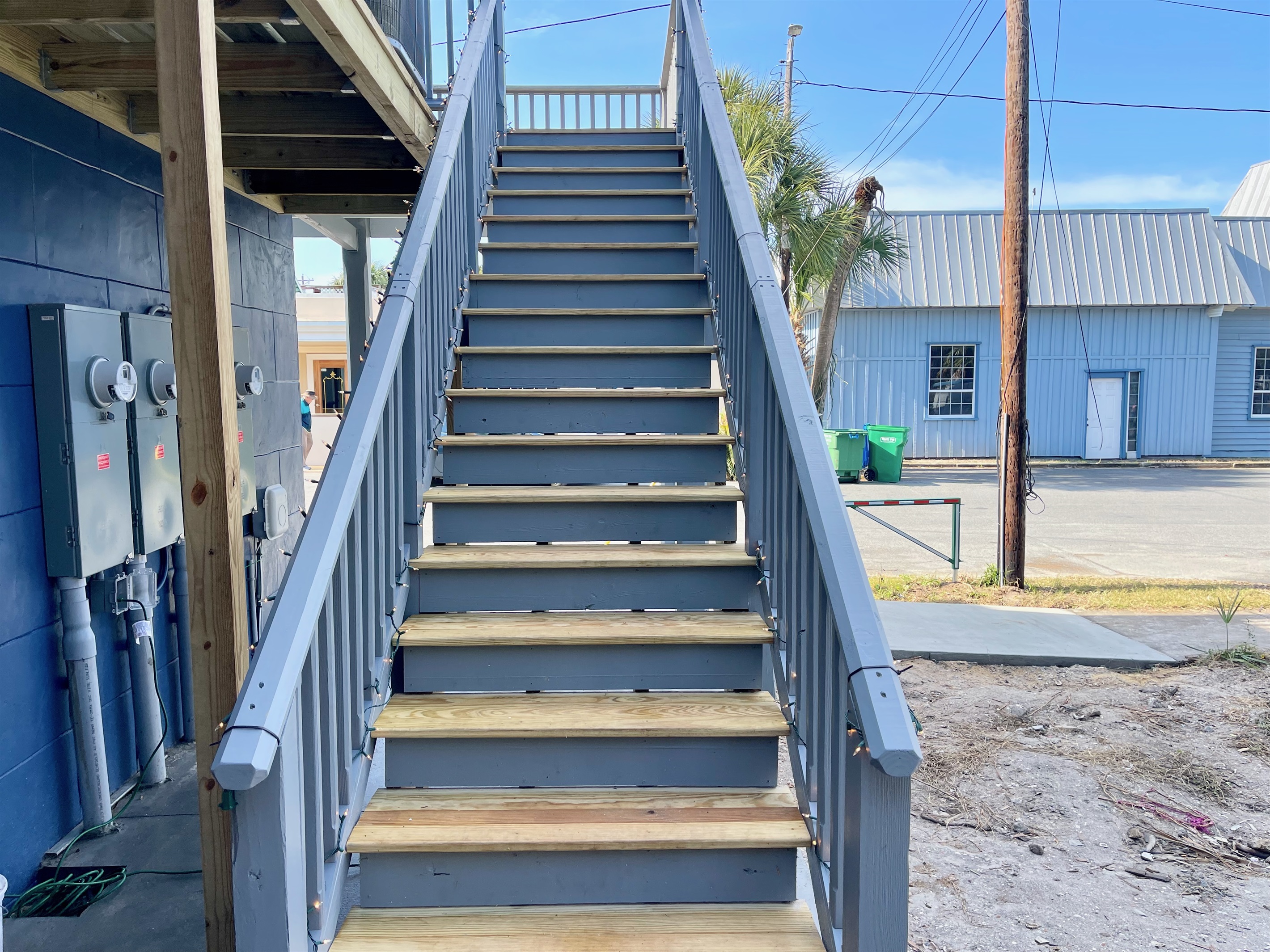 Rear stairs closest to the parking lot leading to apartments