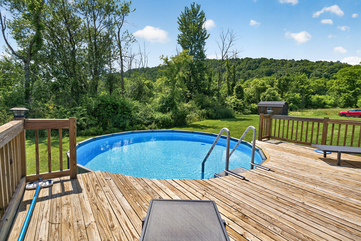 Above-ground pool surrounded by wooden decking