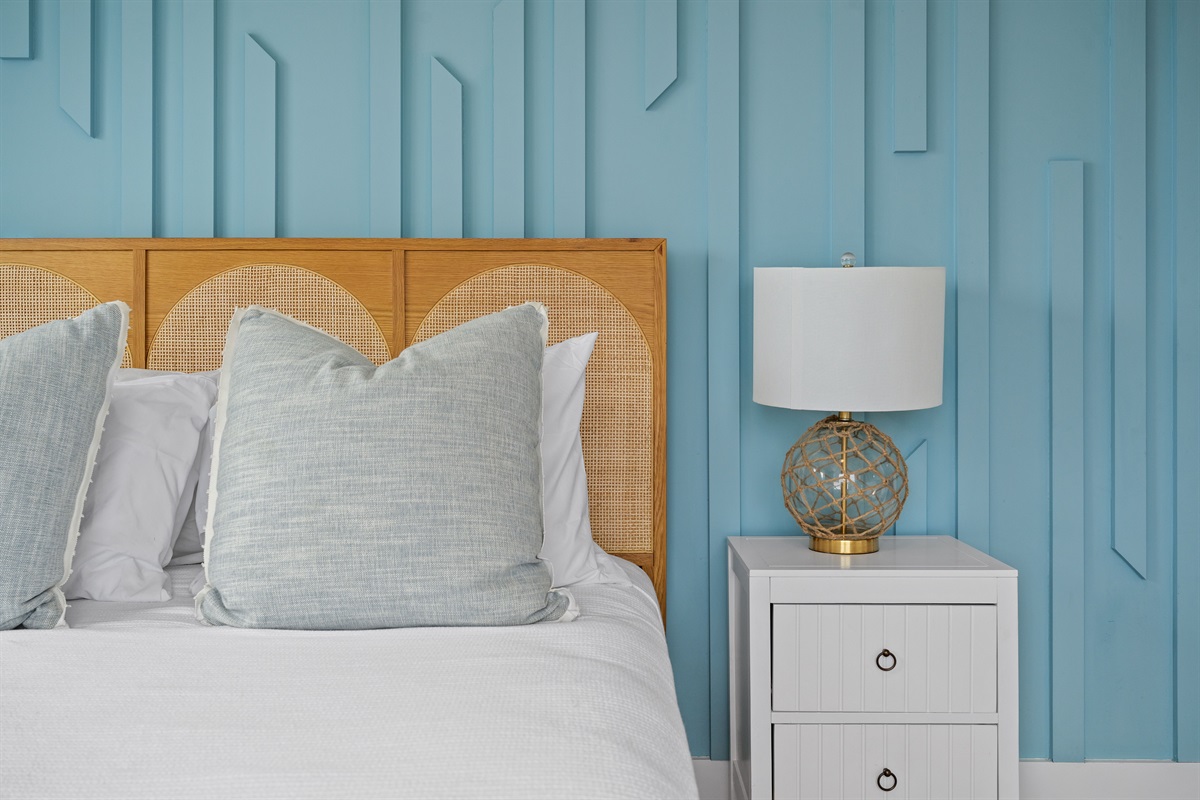 Beautiful accent wall and elegant d&eacute;cor create a relaxing retreat in this private guest bedroom