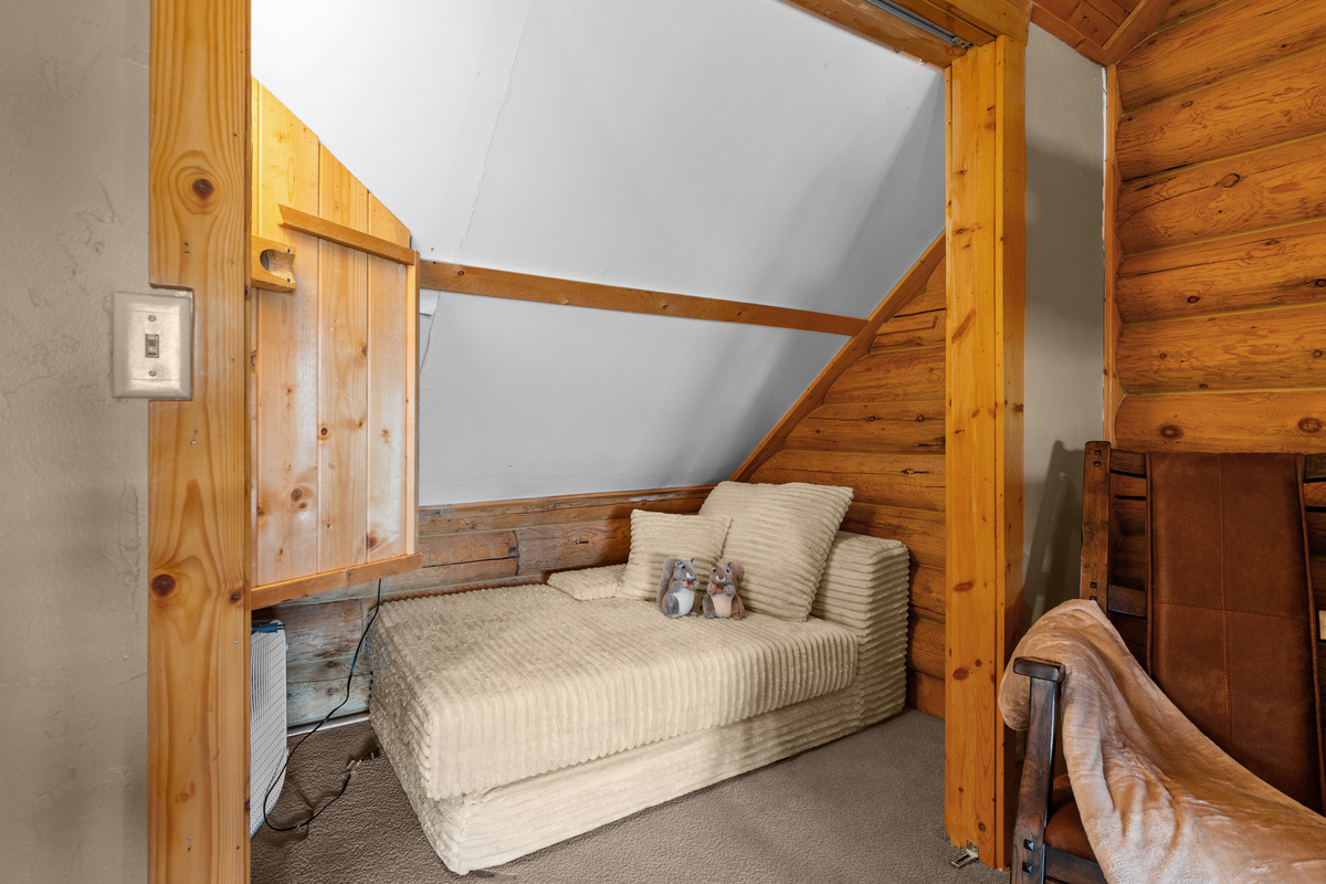 Tucked-away twin lounge bed creating an extra cozy sleeping nook in the loft.