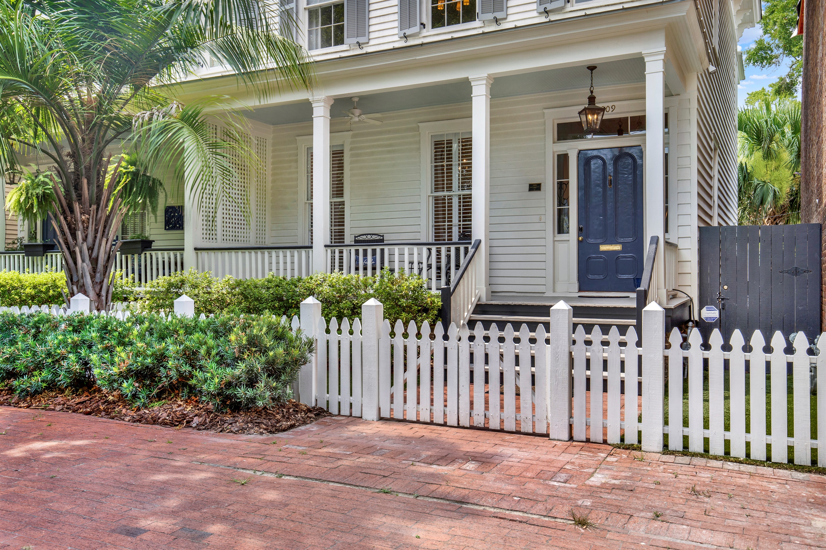 Charming curb appeal with a short white picket fence—straight out of a storybook.