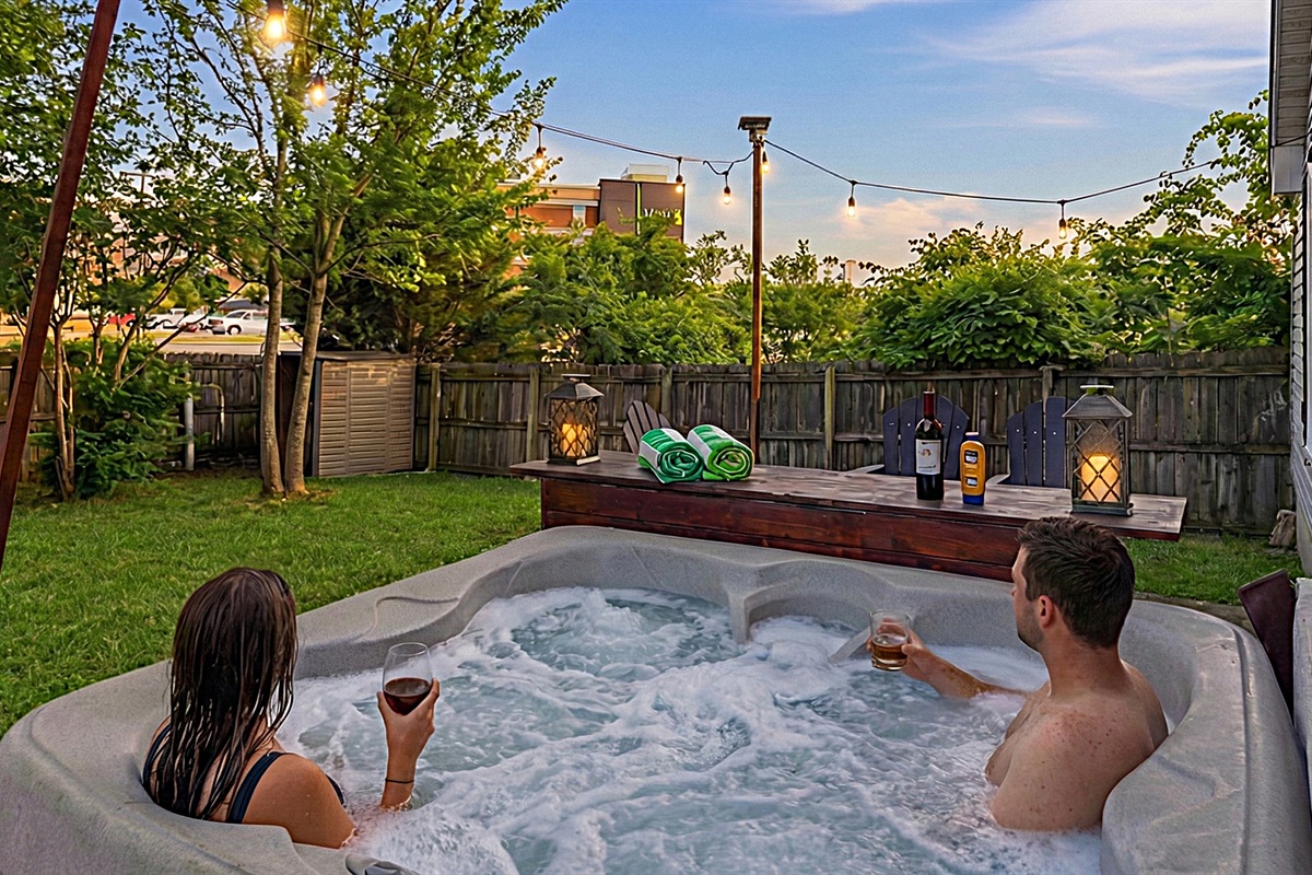 Relax in our private backyard hot tub under ambient solar-powered string lights! Open year-round! (just please no glass in the hot tub).