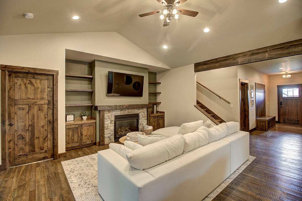 Step through the front door into a beautifully lit living space, where a soft sectional invite you to settle in and relax.
