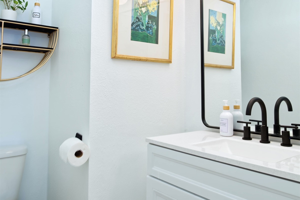 Half bathroom located in lower level next to kitchen