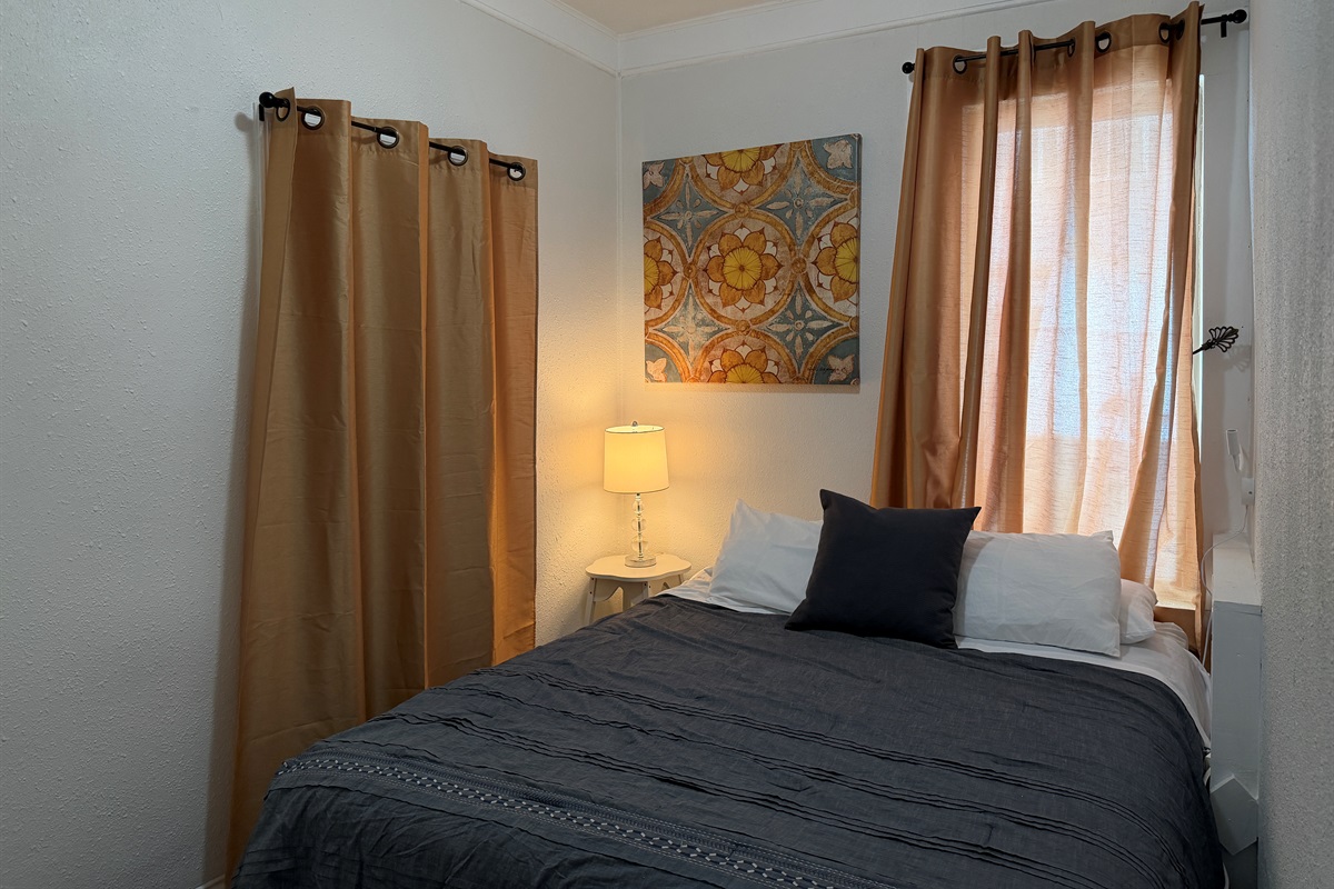 The first floor queen bedroom is cozy and comfortable.
