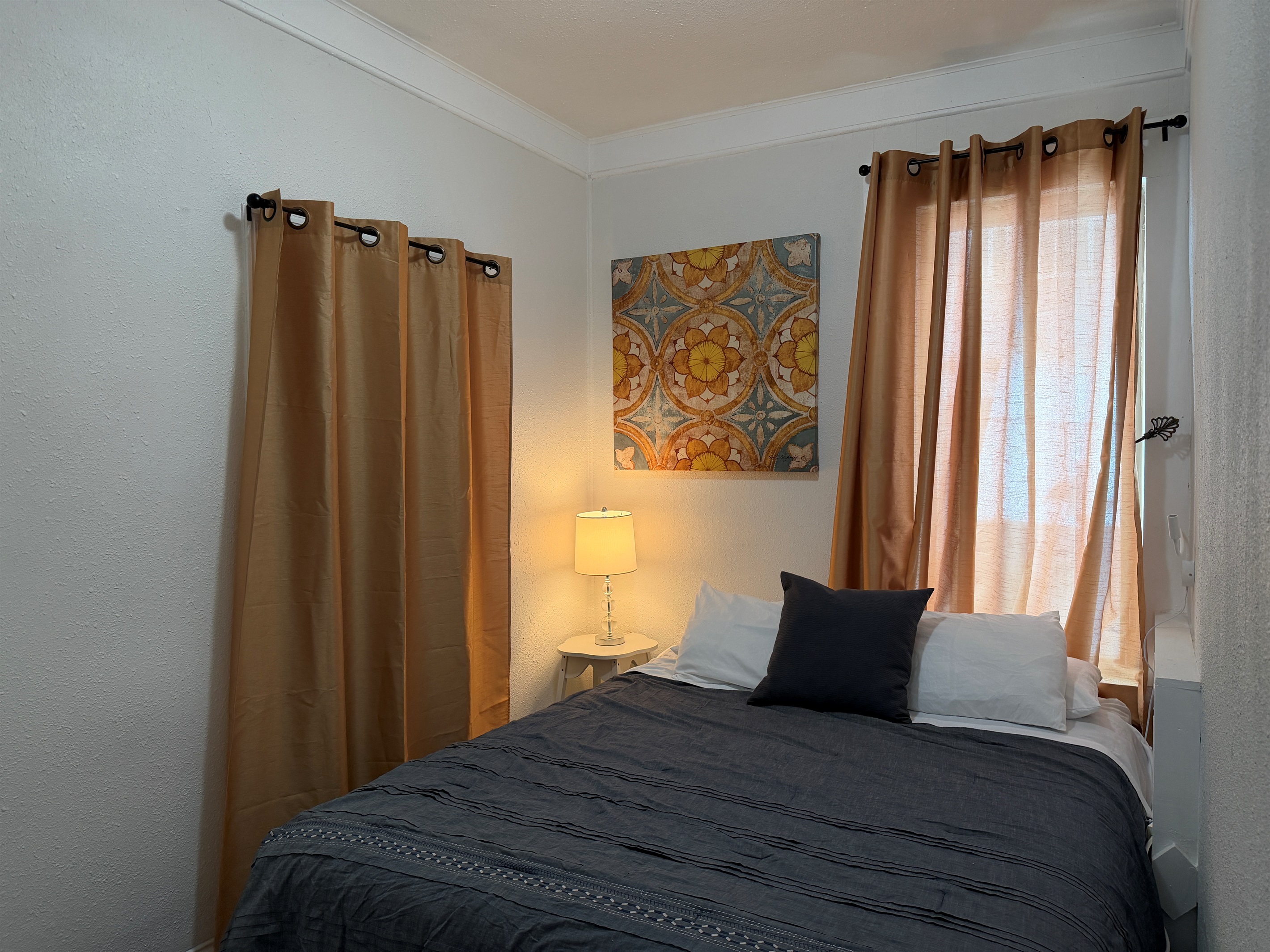 The first floor queen bedroom is cozy and comfortable.