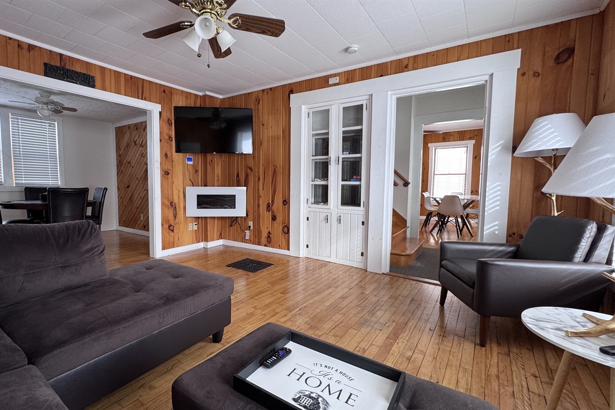 Living room with the game room with poker table to the left.