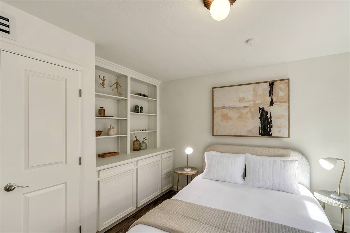 Queen bed and storage in the guest bedroom.