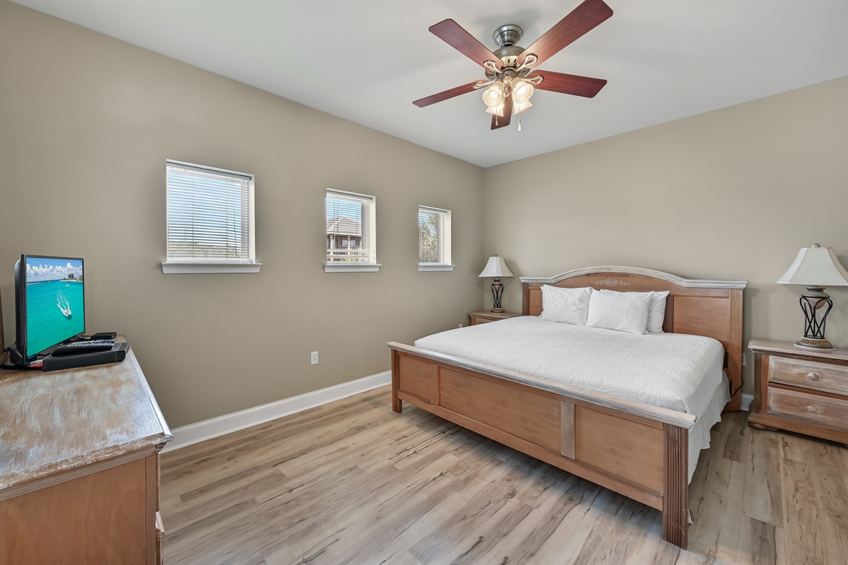 BEDROOM #2 + BATHROOM #2: King Bed with night stands, dresser, and TV. This bedroom has a private bath