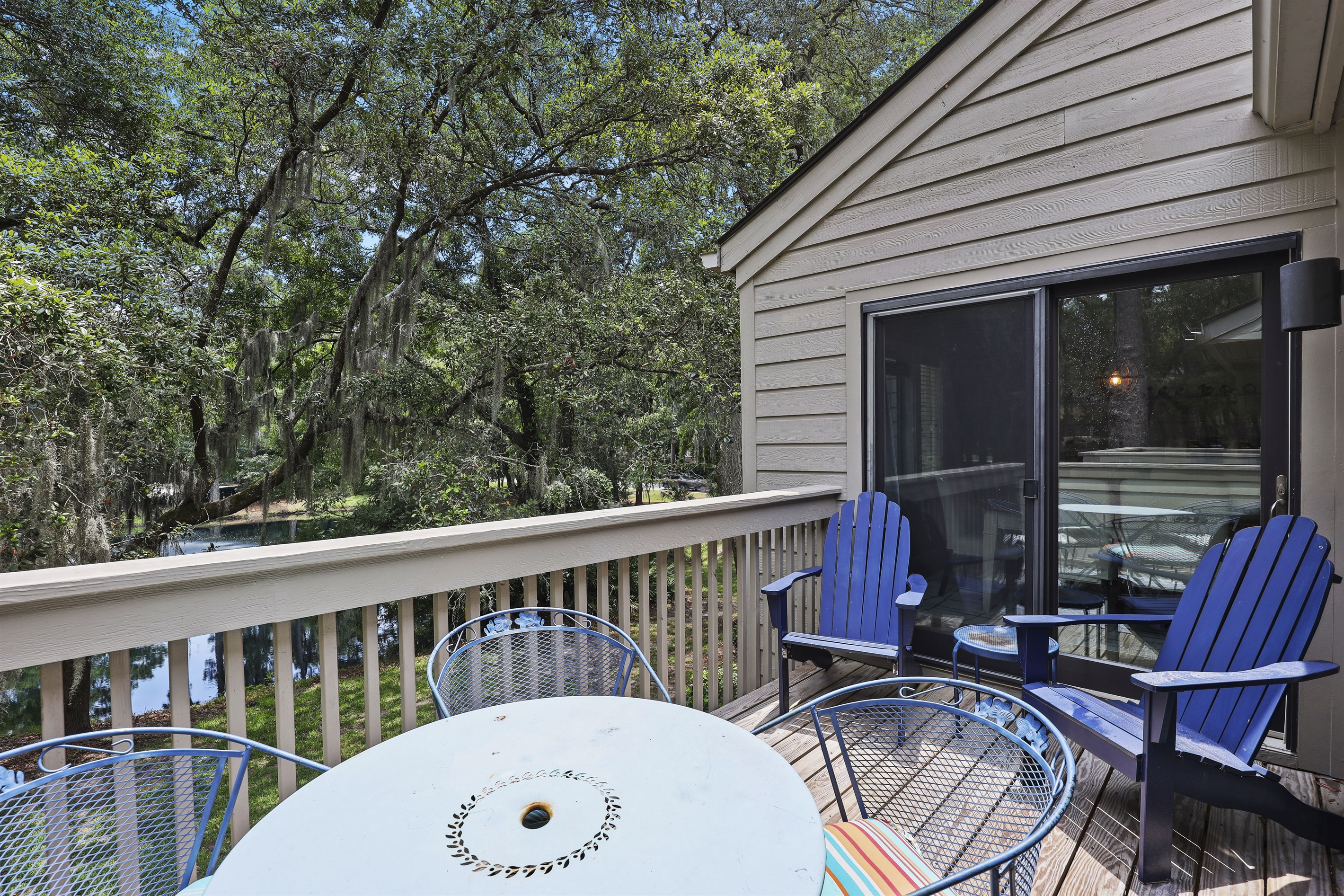 Balcony off the living room gets great morning sun and features a table seating 4 and 2 adirondack chairs