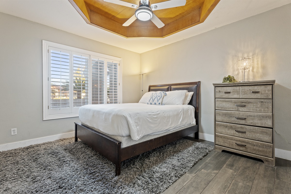 Fresh and functional, the laundry room pairs charming wallpaper with updated appliances and access to the outdoors.