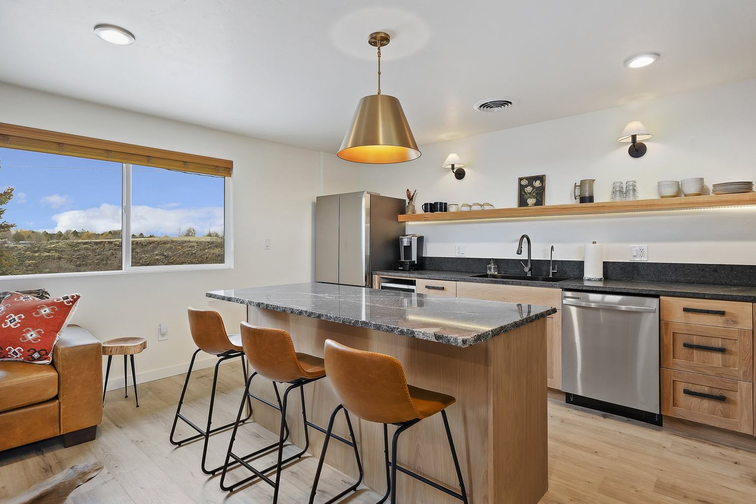 Full kitchen with a dining island — granite counters and stainless appliances