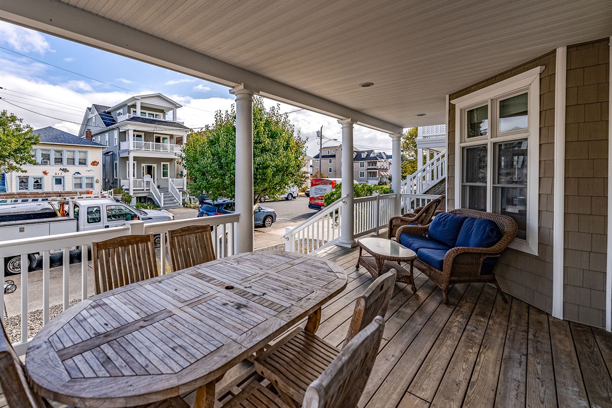 Spacious porch with outdoor dining and furniture