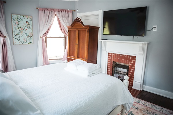 55" Roku tv, ornamental fireplace, and armoire, hangers.